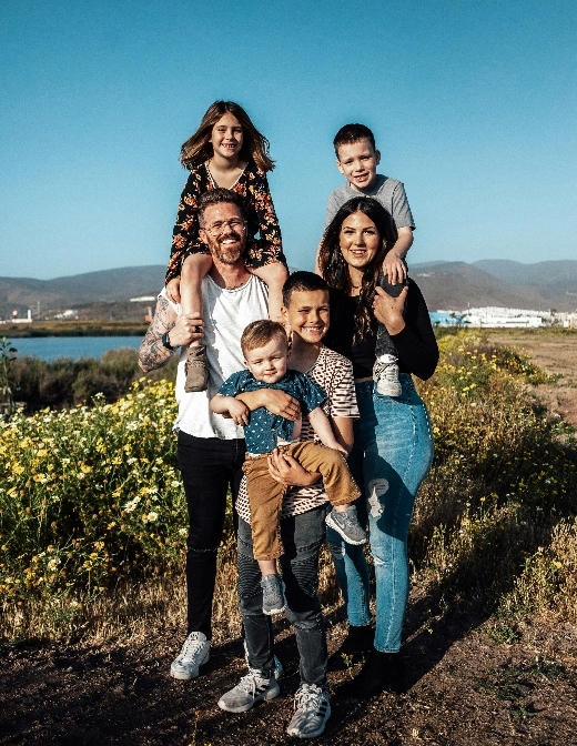 Two parents with four kids. Each parent has a kid on their shoulders