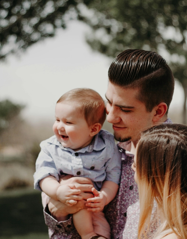 Young dad holding his son